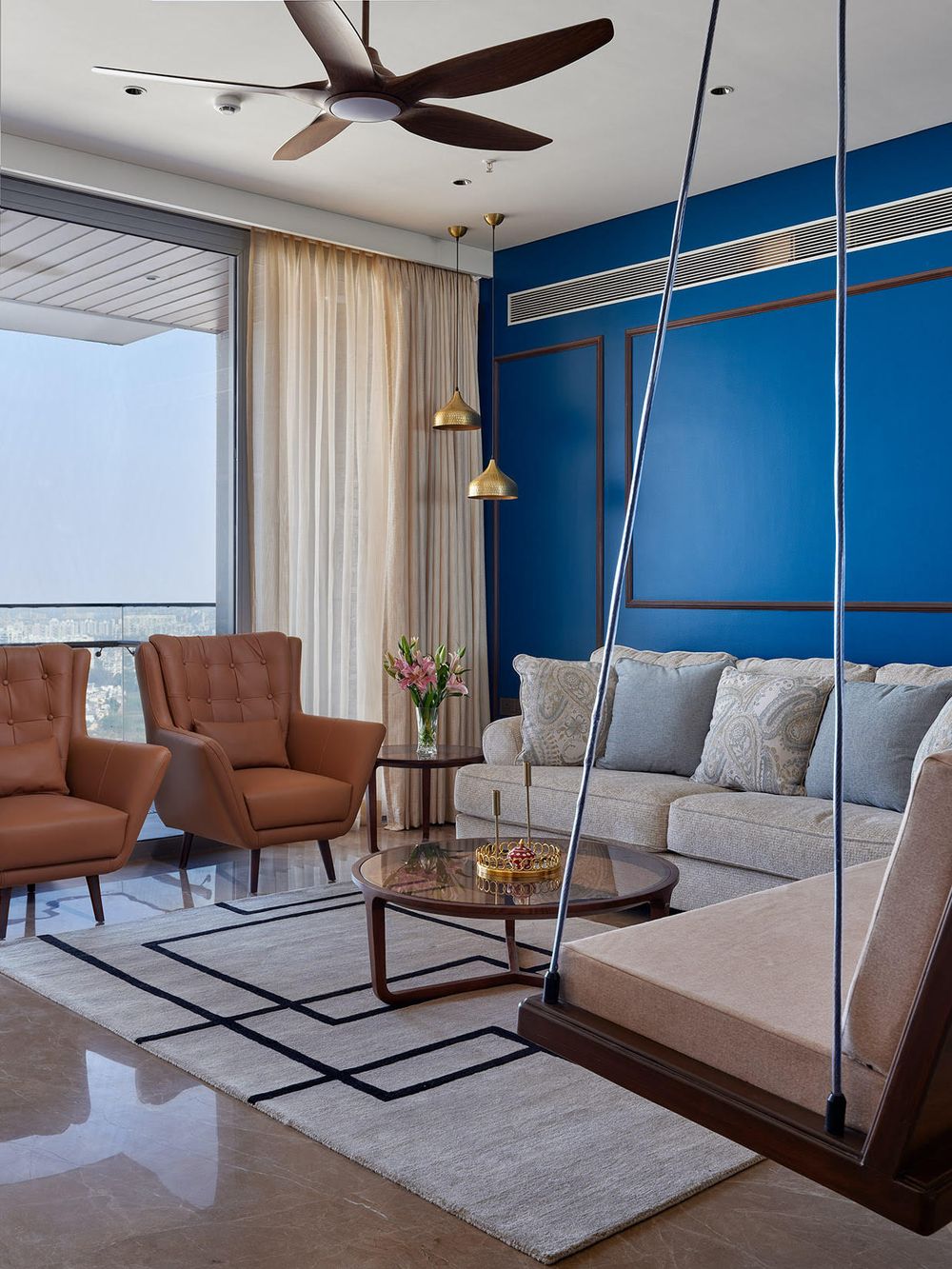 High-rise Pune living room in sky blues and earthy rust, A Symphony of the Earth & the Sky